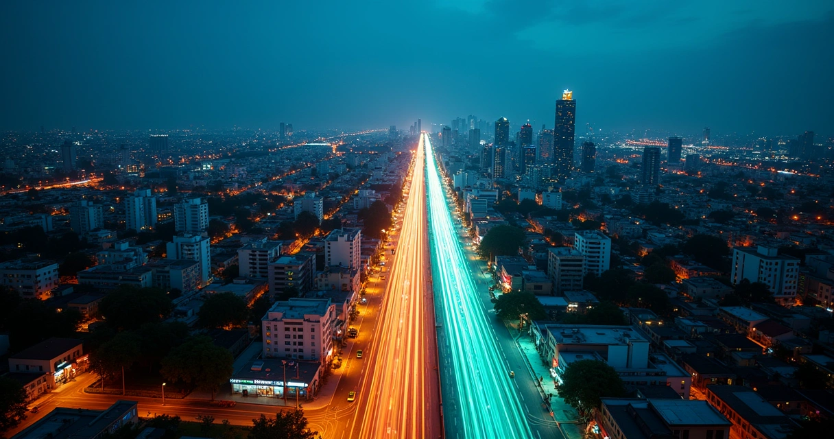 Cidade vista de cima com avenida ganhando destaque em luzes coloridas